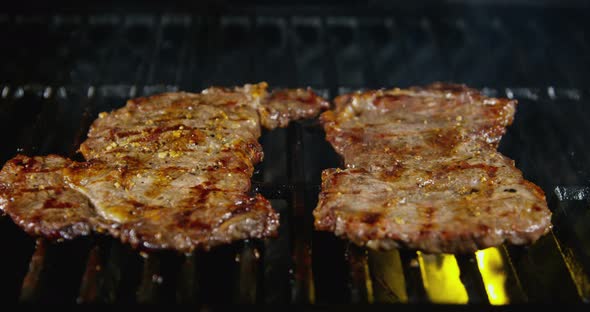 Flipping Juicy Rib Eye Steaks On Grill