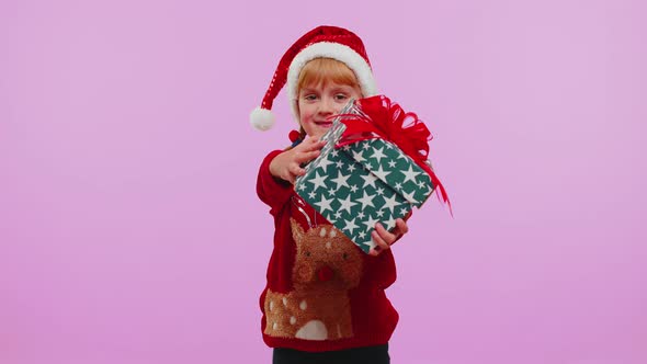 Happy Teen Toddler Girl Kid Wears Red Christmas Sweater Presenting Christmas Gift Box Shopping Sale alt
