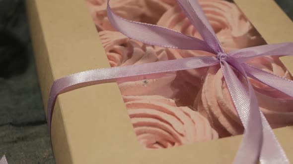 Closeup of a Purple Berry Marshmallow in a Box with a Transparent Top Tied with a Lilac Ribbon