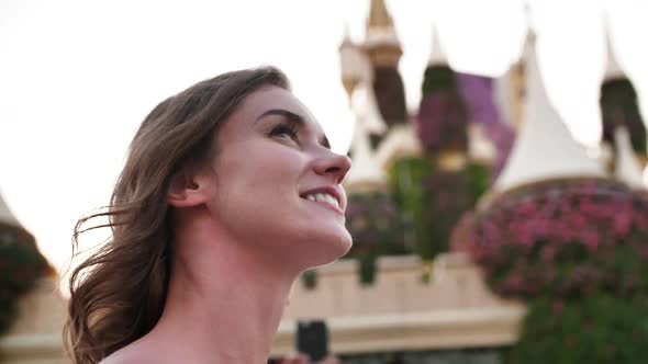 A Girl Walks Through a Beautiful Fairytale Park in Dubai alt