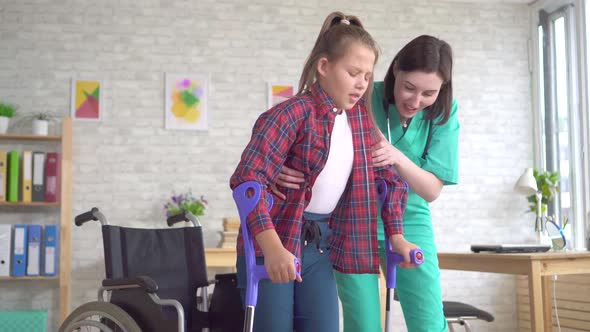 Teenage Girl with Disabilities Undergoing Rehabilitation Program Recovery with a Doctor alt