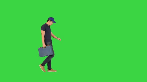Young Builder Walking with a Toolbox Rushing Being Late on a Green Screen Chroma Key