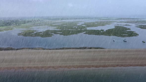 Aerial footage flying through rain on a wet and cold cloudy rainy day in Bournemouth alt