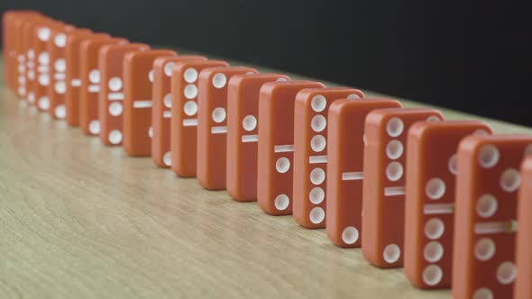 Domino Effect - Red Dominoes Falling Down the Chain alt