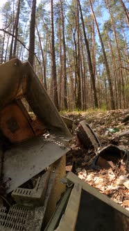 Vertical Video of the Computer in a Junkyard in the Forest alt
