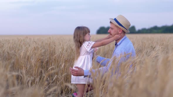 Funny Family Games, Man and a Girl Happy Family Playfully Play on the Field of Ripe Wheat Against alt