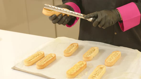 Close up gimbal shot of gloved hands mending ready made tartlet doughs alt