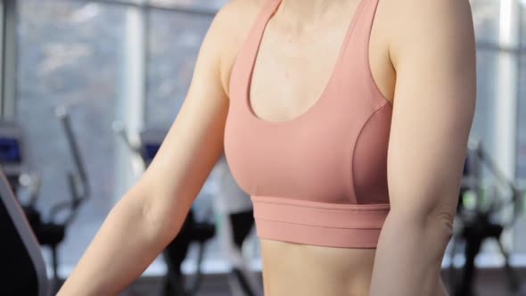 Young woman training on treadmill