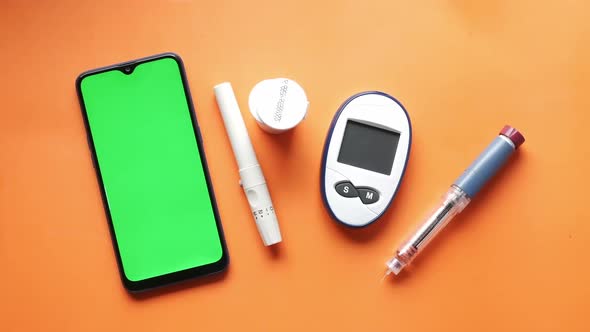 Smart Phone Insulin Diabetic Measurement Tools and Pills on Color Background alt
