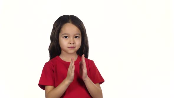 Brunette Girl Claps Her Hands on White Background. Slow Motion alt
