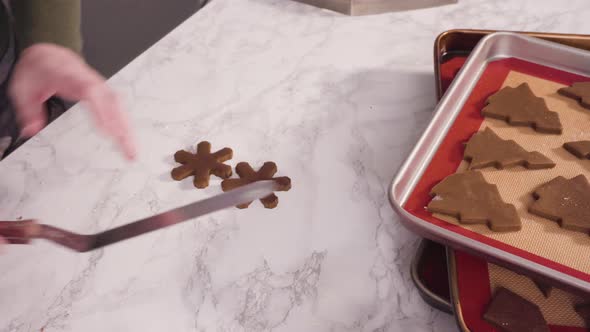 Step by step. Cutting out shapes with Christmas cookies cutter from gingerbread cookie dough. alt