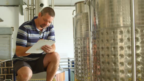 Male worker writing on a clipboard 4k alt