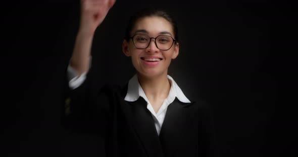 Businesswoman Points Directly at the Camera Chooses you on a Black Background