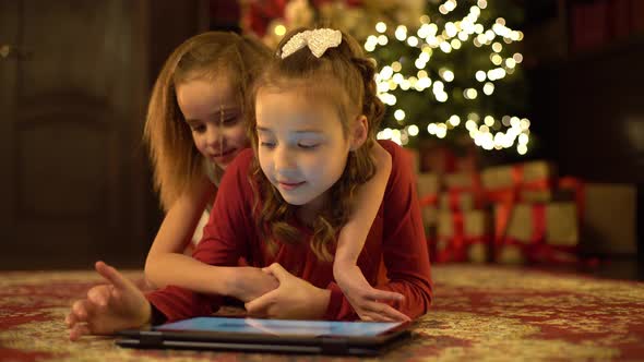Two Little Girls Write Letter To Santa Claus Tablet