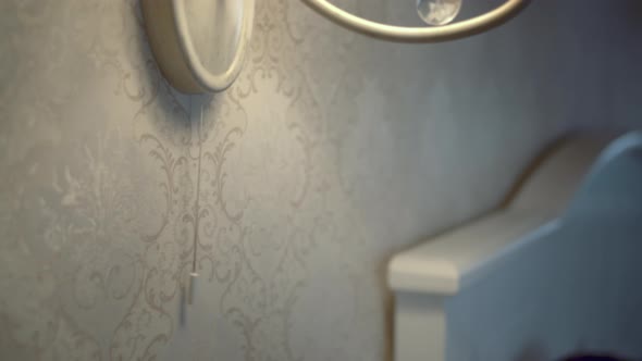 Man's Hand Turns on the Light of the Lamp on the Wall in the Bedroom alt