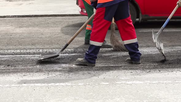 Workers Repair the Road in the City They Prepare the Old Asphalt for Cutting alt