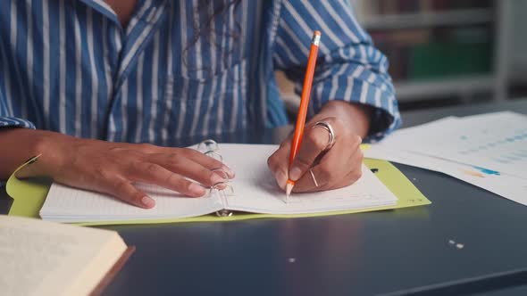 Close Up Hands Ethnic Woman Left Handed Who Writes Something in Journal alt