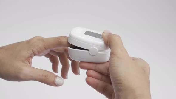 Hand with pulse oximeter or blood oxygen level measure monitor device alt