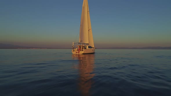 Sailboat over the Calm Waters of Spain During Sunset alt