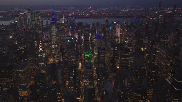Aerial Evening Footage of Rows of Skyscrapers Along Streets in Midtown alt