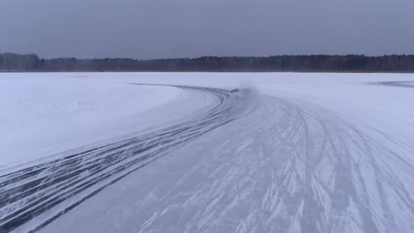 Aerial View of The Rally Car on A Snowy Road