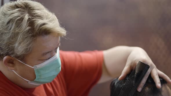 A Commercial Video of Barber Making Haircut of Attractive Man in Barbershop alt