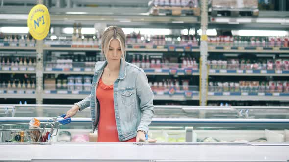 Supermarket with a Woman Putting Frozen Food Into a Cart, Stock Footage