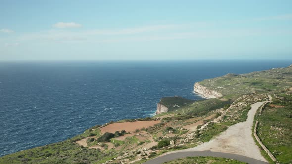 AERIAL: Dingli Cliffs with Greeny Nature and Blue Sea and Sky in Malta Island