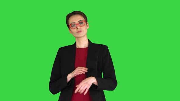 Young Fashionable Woman with Folded Hand on a Green Screen, Chroma Key. alt