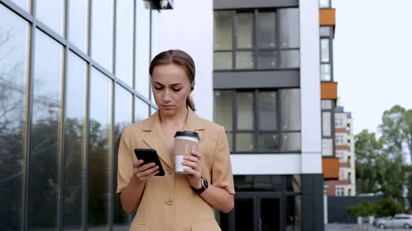 Confident Businesswoman walking on Parking near big modern Business district alt