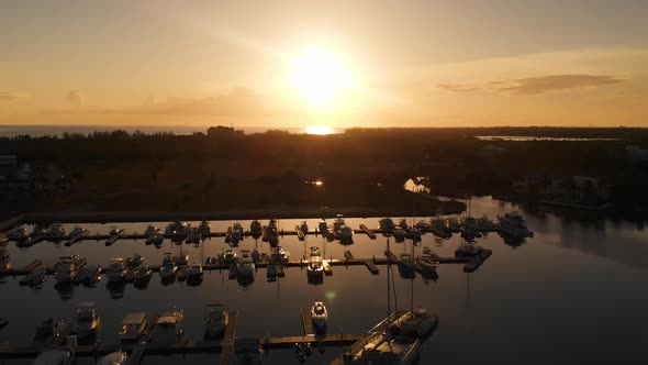 Aerial video of Grand Cayman Yacht Club Marina in the Cayman Islands at sunset alt