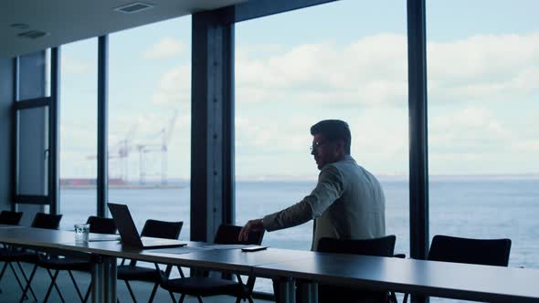 Man Expert Reading Documents at Marina Seaport Rear View alt