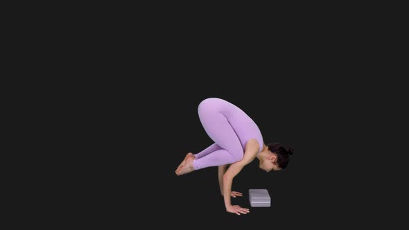 Young Woman in Bodysuit Doing Crow Pose While Practicing Yoga, Alpha in