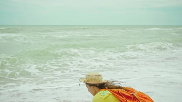 Panoramic View Beautiful Ocean Beach with Waves and Cloudy Sky Rear View Woman in Hat and Summer alt