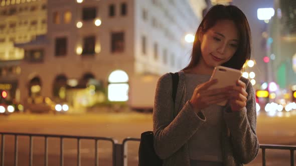 Woman using cellphone at night alt