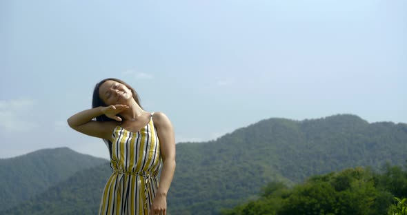 Cheerful Woman Is Dancing Outdoors in Sunny Summer Day, Rising Hands Up and Smiling alt