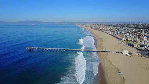 Aerial drone uav view of a pier over the beach and ocean alt