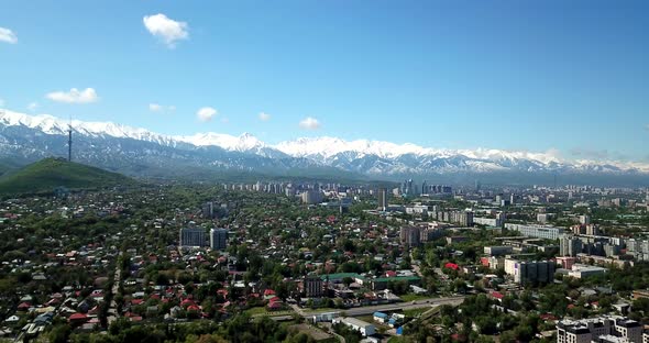Green City with Snowy Mountains of Almaty alt