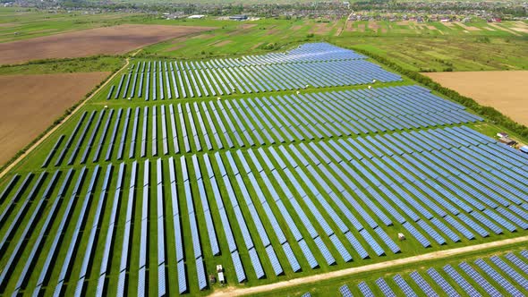 Aerial View of Big Sustainable Electric Power Plant with Many Rows of Solar Photovoltaic Panels for alt