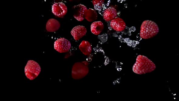 Top View of the Raspberries Bouncing and Rotating with the Drops of Water alt