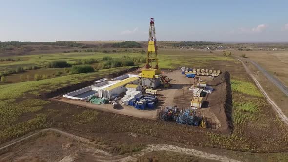 Large Oil Well in Field, Aerial View of Industrial Equipment