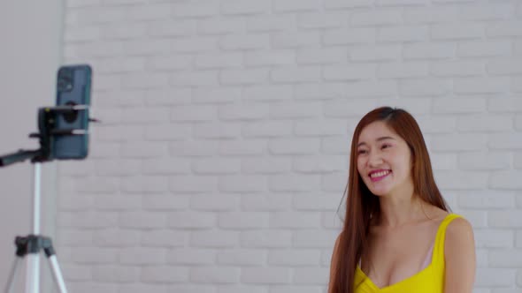 Content Creator of Asian young woman using mobile phone take dancing video clips alt