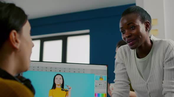 Team of Multiethnic Retouchers Working with Modern Photo Editing Software alt