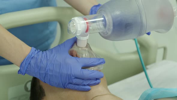 Doctors give resuscitation to a male patient in the emergency room. Cardiac mass