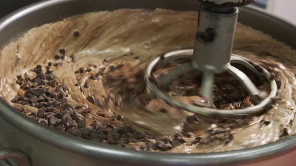 Mixing ingredients for chocolate fudge at candy factory