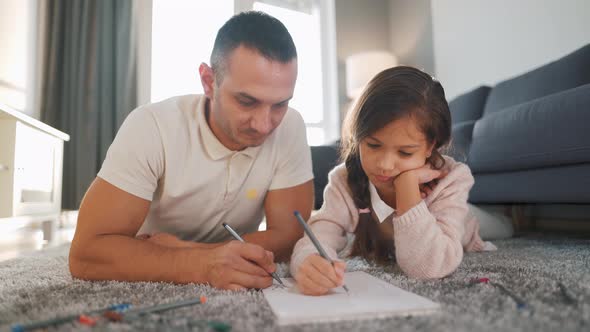 Father and Daughter Communicate Having Fun and Painting Together alt