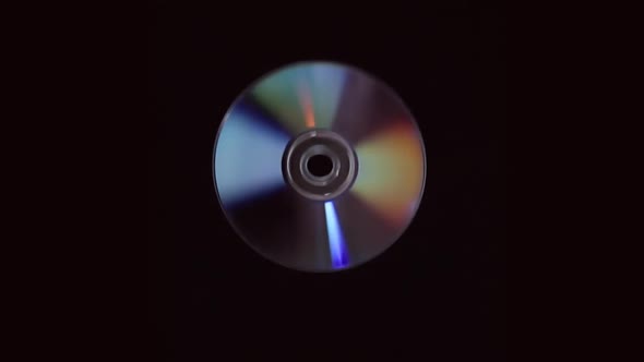 Compact Disc Glitter, Flies And Rotates On A Black Background In Slow Motion