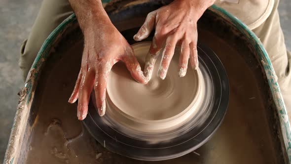 Mid section of potter making pot alt