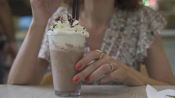 Chocolate Frappe or Frapuccino with Woman Hand Stirring Iced alt