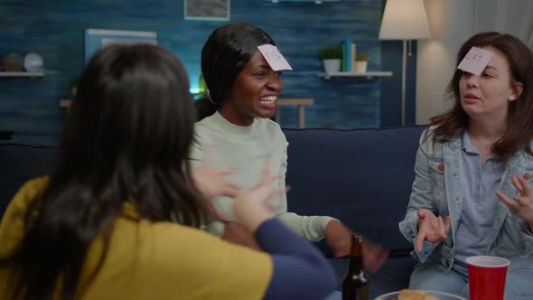 Multiethnic Friends Enjoying Time Together While Relaxing on Couch alt